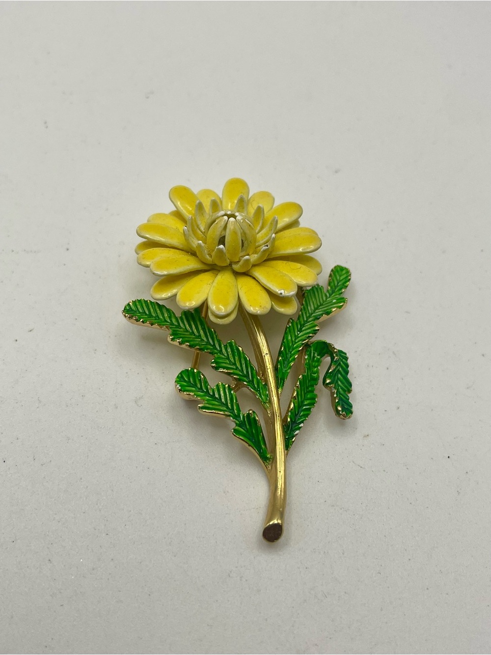 Vintage Crown Trifari Rare Yellow Enamel Flower Brooch with Green Leaves.